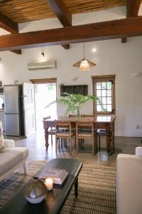 a living room with a table and a kitchen at Vineyard Cottage at Bosman Wines in Wellington