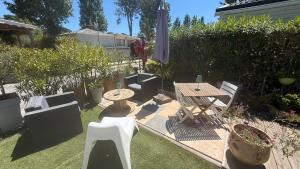 a backyard with a table and chairs and a table and sidx sidx sidx at My Freedom in Hyères
