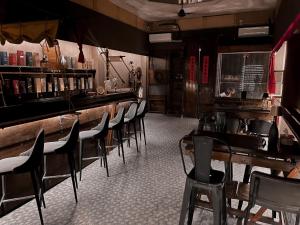 a bar with chairs and tables in a restaurant at Astrid Lofts in Ipoh