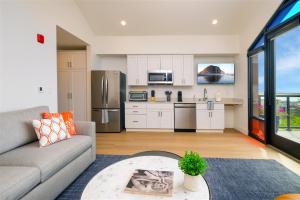 a living room with a couch and a kitchen at Harbor View 101 in Morro Bay