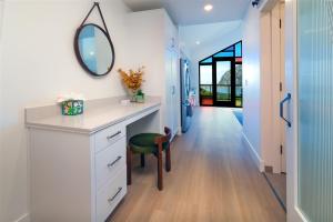 a bathroom with a vanity and a mirror on the wall at Harbor View 101 in Morro Bay +15 photos