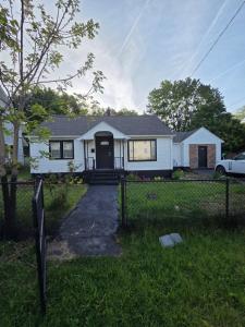 a white house with a fence in front of it at Berwyn Alimot Proshortlet-home LLC in Syracuse