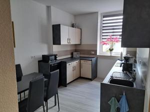 a small kitchen with a table and a counter top at NEU! Fewo Calbe an der Saale in Calbe