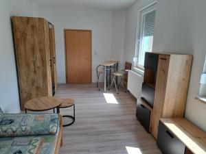 a living room with a couch and a table and chairs at NEU! Fewo Calbe an der Saale in Calbe