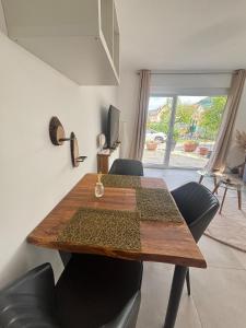 a dining room table with black chairs and a table and a window at Casa Nova Apartment in Geislingen an der Steige