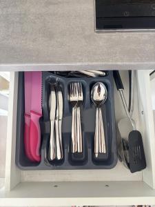 a drawer filled with utensils in a drawer at Casa Nova Apartment in Geislingen an der Steige
