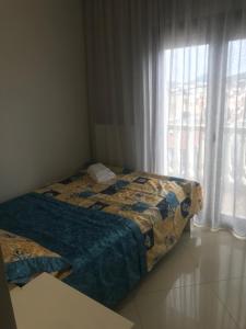 a bedroom with two beds and a window at Rias house in Nea Peramos