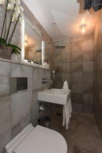uma casa de banho com um lavatório branco e um WC. em Hotel Mezzo em Sälen