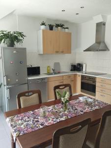 a kitchen with a table with a table cloth on it at Ferienwohnung Lottstetten in Lottstetten