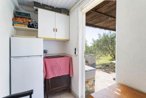 a kitchen with a refrigerator and a door to a yard at Gite Insolite Mas Boutet in Argelès-sur-Mer +35 photos