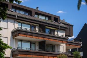 a building with balconies on the side of it at Welcome in - Studio 57-S mit Balkon, 200 m von der Skipiste entfernt in Winterberg