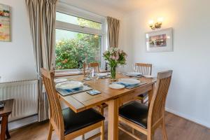 a dining room with a wooden table and a window at 2 Bed in Looe oc-l30026 in Looe