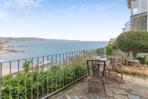 a balcony with a table and chairs and the ocean at 2 Bed in Looe oc-l30026 in Looe