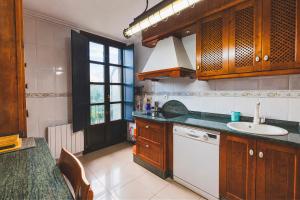a kitchen with a sink and a counter top at Apartamento Parque Portovello in Allariz +28 photos