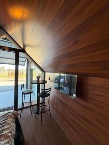 a room with a bed and a table and chairs at Alta Vista Cabanas in Garibaldi
