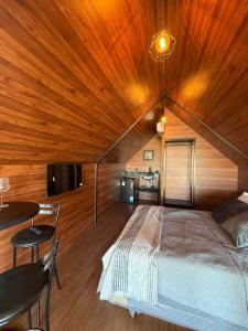 a bedroom with a large bed with a wooden ceiling at Alta Vista Cabanas in Garibaldi