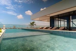 an image of a swimming pool in a house at Beach Class Meireles by HostFacil in Fortaleza