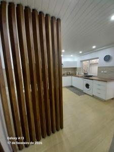a large kitchen with a wooden fence in a room at Apartamento do Chico in Terra Chã +2 photos