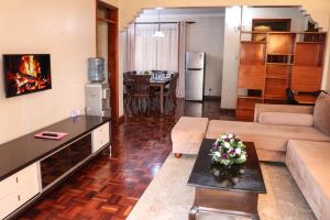 a living room with a couch and a table at Legacy Homes in Nairobi