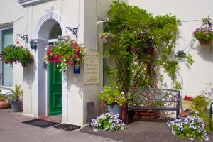 a bench sitting in front of a building with flowers at Apartment 2 in Torquay