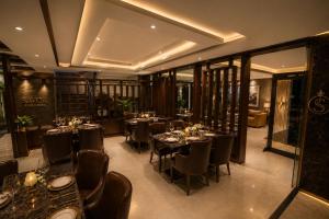 a restaurant with tables and chairs in a room at Hotel Corporate Plaza Near Terminal 3 Delhi International Airport With Free Airport Pickup in New Delhi