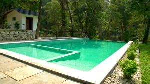 a swimming pool in the middle of a yard at La Damai in Aldūr