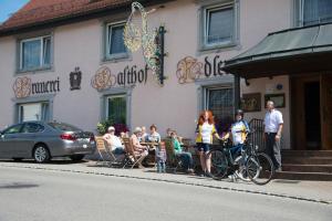 a group of people sitting outside of a building at Brauereigasthof ADLER in Herbertingen