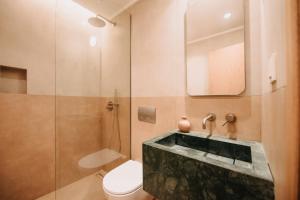 a bathroom with a sink and a toilet and a shower at Hotel Apollon Corfu in Paleokastritsa