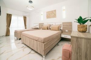 a bedroom with two beds and a table at Villa Champion in Ulcinj +91 photos