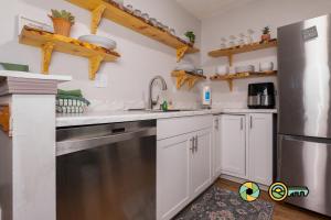 a kitchen with white cabinets and a stainless steel refrigerator at Lakeview 10B: Forest Den in Basye
