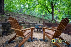 two wooden chairs and a table and a fire pit at Lakeview 10B: Forest Den in Basye