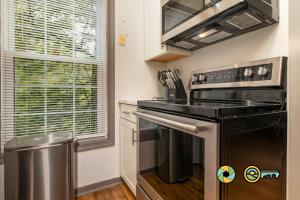 a kitchen with a stove and a trash can at Lakeview 10B: Forest Den in Basye +22 photos