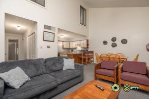 a living room with a couch and a dining room at Senedo Springs Duplex #90A in Basye