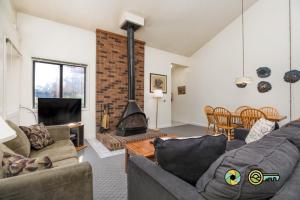 a living room with a couch and a fireplace at Senedo Springs Duplex #98A in Basye