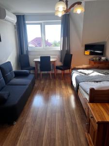 a room with a bed and a table and chairs at Szyper 2 in Jastarnia