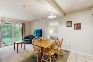 a living room with a wooden table and chairs at Seasons 207 in Warren