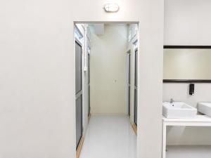 a white bathroom with a sink and a mirror at Astrid Lofts in Ipoh +45 photos