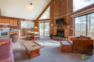 a living room with a couch and a fireplace at Villa #162 in Basye