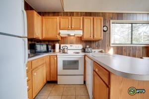 a kitchen with wooden cabinets and a white stove top oven at Villa #162 in Basye