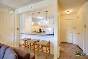 a kitchen with a counter and stools in a room at Aspen East Unit #122 in Basye