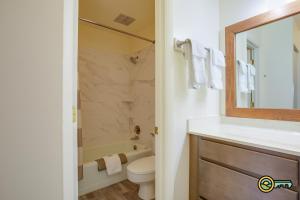 a bathroom with a sink and a toilet and a mirror at Aspen East Unit #122 in Basye +18 photos