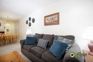 a living room with a brown couch with blue pillows at Senedo Springs Condo #2-202 in Basye