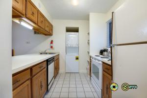 a kitchen with a white refrigerator and a sink at Senedo Springs Condo #2-202 in Basye