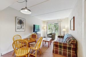 a living room with a table and a couch at Seasons 200 in Warren