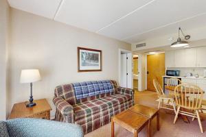 a living room with a couch and a table at Seasons 200 in Warren