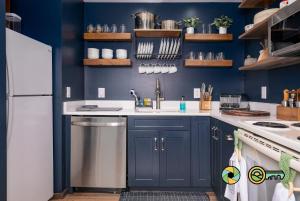 a blue kitchen with a sink and a dishwasher at The Hill T-19: Eagle's Nest in Basye