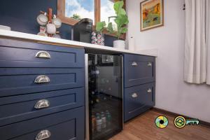 a kitchen with a blue cabinet with a wine refrigerator at The Hill T-19: Eagle's Nest in Basye