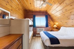 a bedroom with a bed in a wooden cabin at Chalet #16 in Stevensville +34 photos