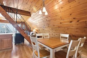 a dining room with a wooden wall and a table and chairs at Chalet #16 in Stevensville