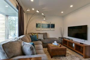 a living room with a couch and a flat screen tv at Lake House - Lake Views in Kimberling City